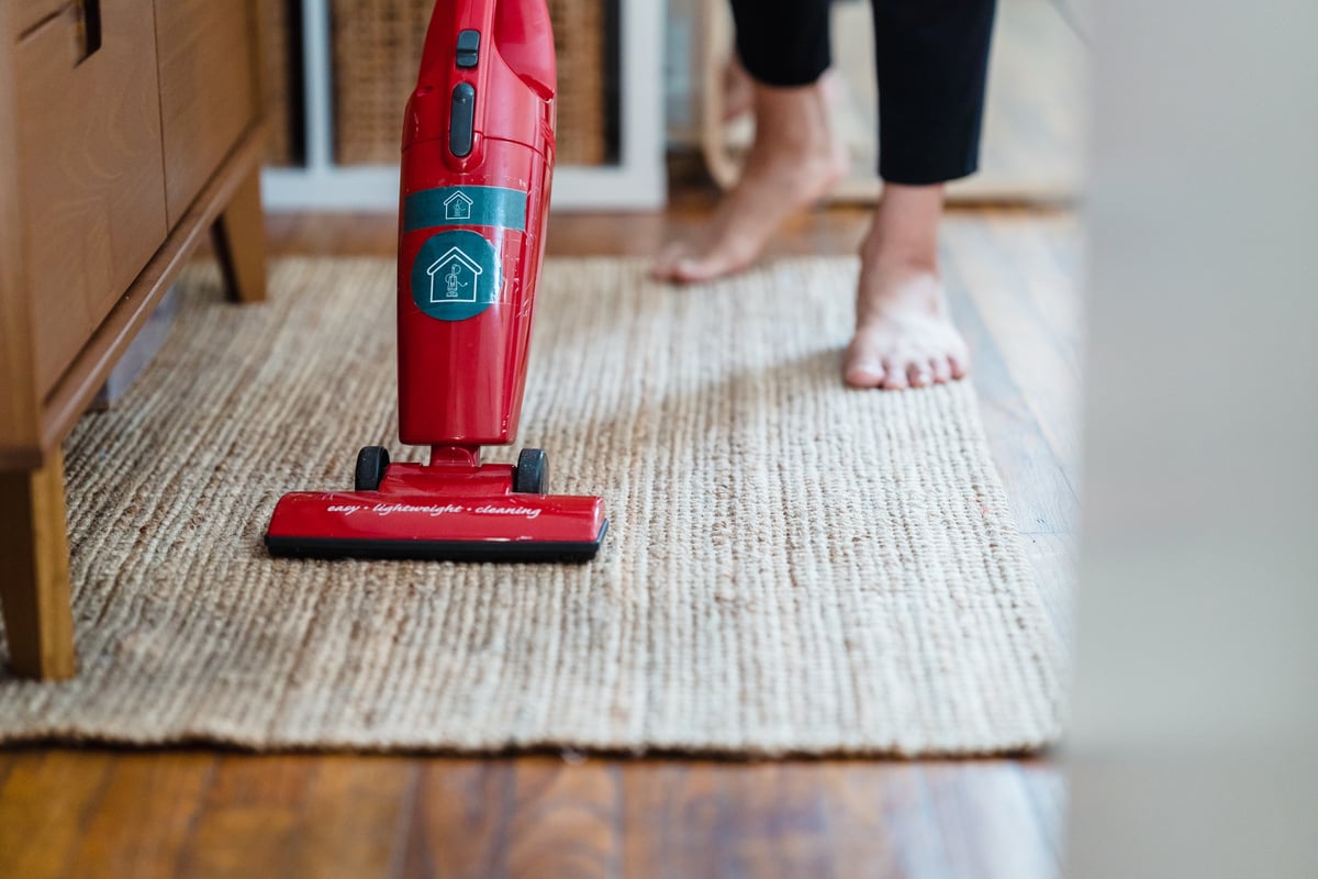 Red Vacuum Cleaner on Brown Carpet